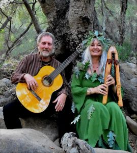 Jon and Sabrine Kurz-Sherman holding instruments in forest